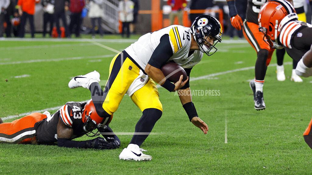 Ron Schwane Pittsburgh Steelers quarterback Mitch Trubisky (10) slips the tackle of Cleveland Browns safety John Johnson III (43) and dives for the end zone for a touchdown during the first half of an NFL football game in Cleveland, Thursday, Sept. 22, 2022. (AP Photo/Ron Schwane)