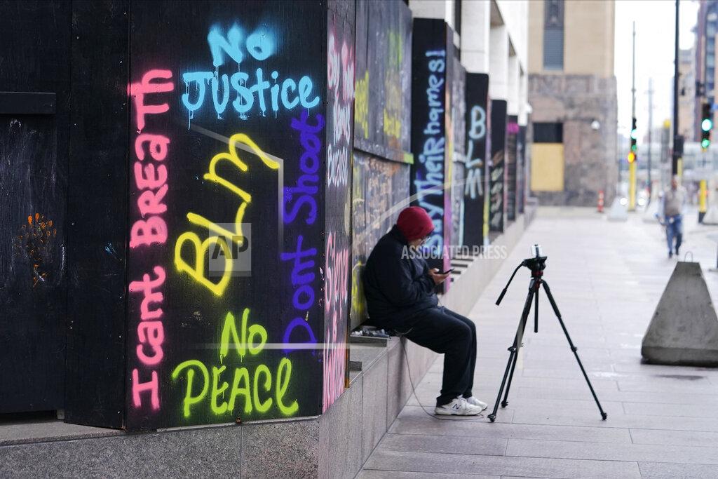 Jim Mone A person videotapes across the street from the Hennepin County Government Center, Thursday, April 8, 2021, in Minneapolis where testimony continues in the trial of former Minneapolis police officer Derek Chauvin. Chauvin is charged with murder in the death of George Floyd during an arrest last May in Minneapolis. (AP Photo/Jim Mone)