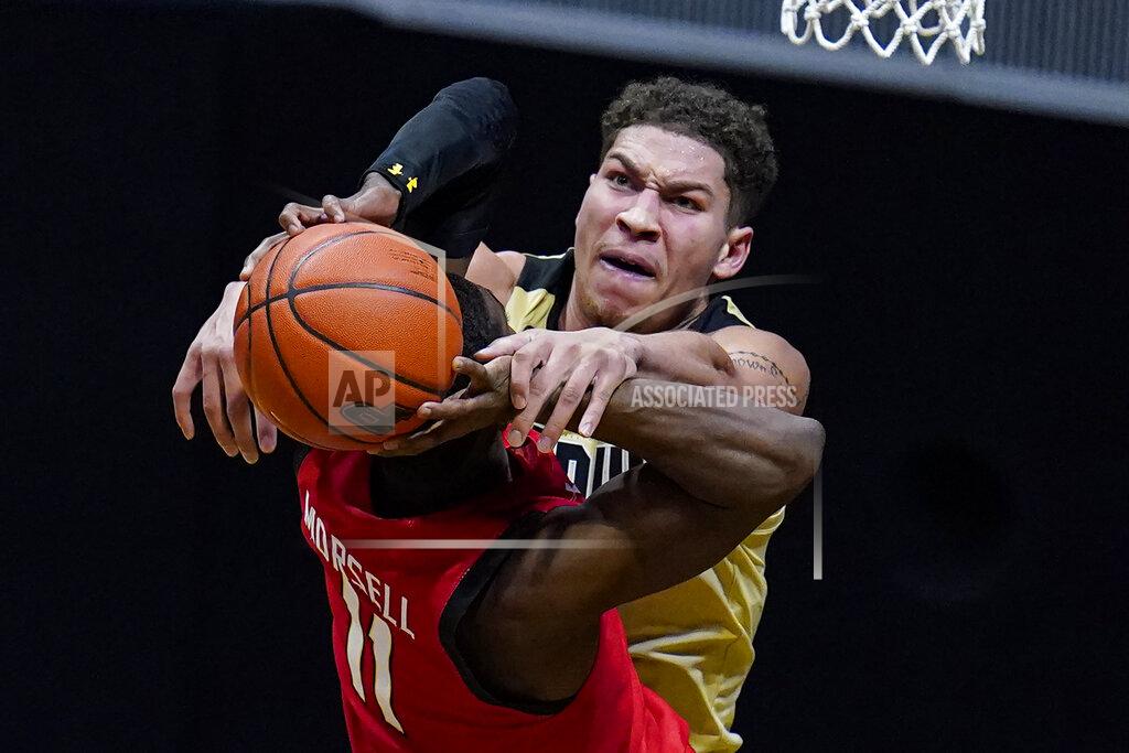 Michael Conroy Purdue forward Mason Gillis (0) fouls Maryland guard Darryl Morsell (11) as he shoots during the second half of an NCAA college basketball game in West Lafayette, Ind., Friday, Dec. 25, 2020. (AP Photo/Michael Conroy)