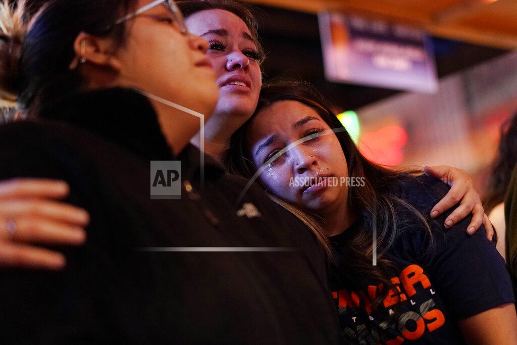 John Locher Bryanna Saiz, right, cries with others during a memorial for Jackson Zinn at a Texas Roadhouse restaurant, Thursday, March 17, 2022, in Hobbs, New Mexico. Zinn, who worked at the restaurant, was killed with several other student golfers and the coach of University of the Southwest in a crash in Texas. (AP Photo/John Locher)
