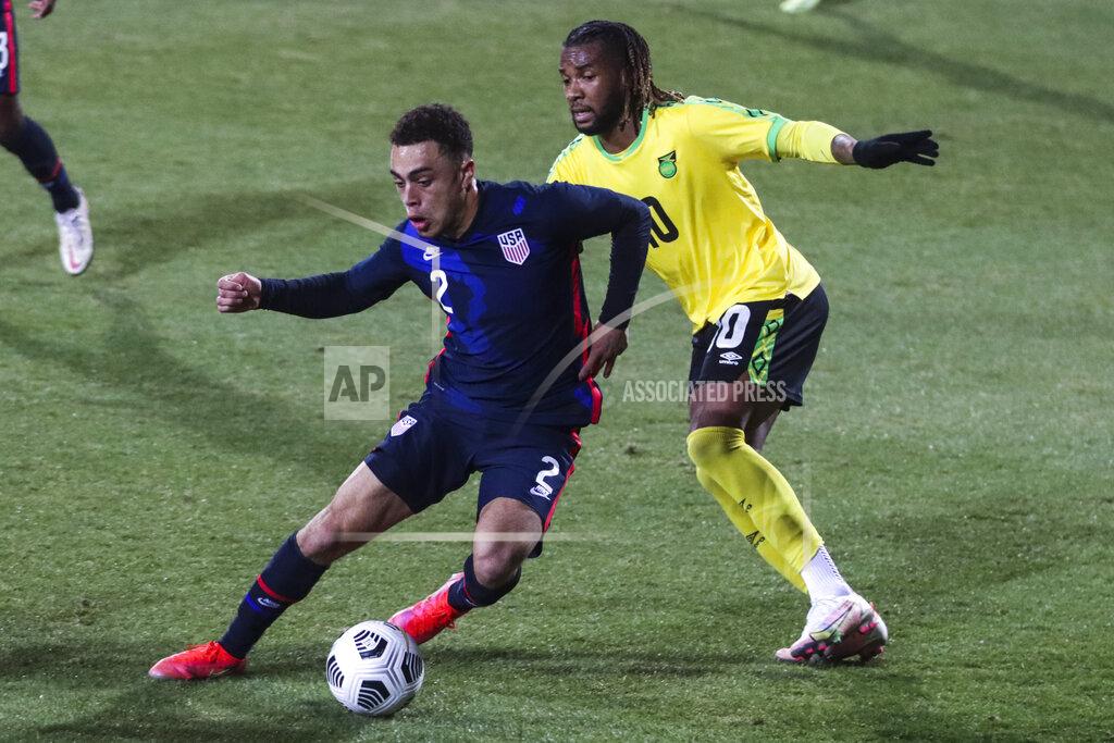 Ronald Zak USA's Sergino Dest, left, duels for the ball with Jamaica's Kasey Palmer during the international friendly soccer match between USA and Jamaica at SC Wiener Neustadt stadium in Wiener Neustadt, Austria, Thursday, March 25, 2021. (AP Photo/Ronald Zak)