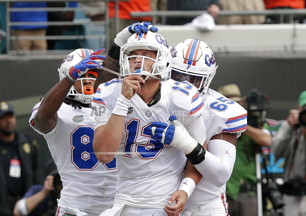 John Raoux Florida wide receiver Tyrie Cleveland, left, and offensive lineman Jawaan Taylor, right, celebrate with quarterback Feleipe Franks (13) after he scored a touchdown on a 1-yard run against Georgia during the first half of an NCAA college football game Saturday, Oct. 27, 2018, in Jacksonville, Fla. (AP Photo/John Raoux)