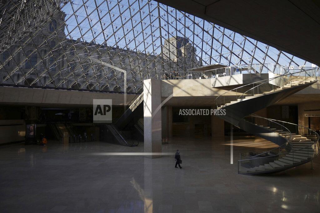 Thibault Camus A man walks through the deserted Louvre museum, in Paris, Thursday, Feb. 11, 2021. It's uncertain when the Louvre will reopen, after being closed on Oct. 30 in line with the French government's virus containment measures. But those lucky enough to get in benefit from a rarified private look of collections covering 9,000 years of human history -- with plenty of space to breathe. (AP Photo/Thibault Camus)