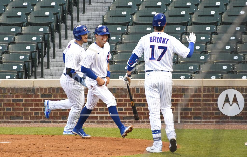 David Banks Chicago Cubs' Ian Happ, left, is greeted by Nico Hoerner, center, and Kris Bryant (17) after hitting a two-run home run against the Milwaukee Brewers during the third inning of an opening day baseball game Friday, July, 24, 2020, in Chicago. (AP Photo/David Banks)