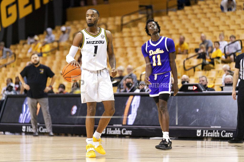L.g. Patterson Missouri's Amari Davis, left, dribbles the ball in front of Paul Quinn's Anei Anei-Yor, left, as the last seconds tick off the clock during an NCAA college basketball game Monday, Nov. 29, 2021, in Columbia, Mo. Missouri won 91-59. (AP Photo/L.G. Patterson)