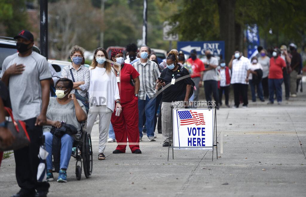 Michael Holahan FILE - In this Oct. 12, 2020, file photo, people wait in line for early voting at the Bell Auditorium in Augusta, Ga. The sweeping rewrite of Georgia's election rules that was signed into law by Republican Gov. Brian Kemp Thursday, March 25, 2021, represents the first big set of changes since former President Donald Trump's repeated, baseless claims of fraud following his presidential loss to Joe Biden. Georgia’s new, 98-page law makes numerous changes to how elections will be administered, including a new photo ID requirement for voting absentee by mail. (Michael Holahan/The Augusta Chronicle via AP, File)