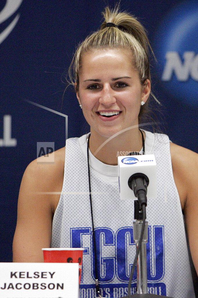 FILE - In this March 17, 2012, file photo, Florida Gulf Coast guard Kelsey Jacobson answers a question during a news conference before basketball practice in Tallahassee, Fla. Kelsey Diemer, formerly Jacobson, feels the same energy as a doctor that she did a few years ago when she was among the best 3-point shooters in college basketball. Her current opponent: The coronavirus. (AP Photo/Steve Cannon, File)