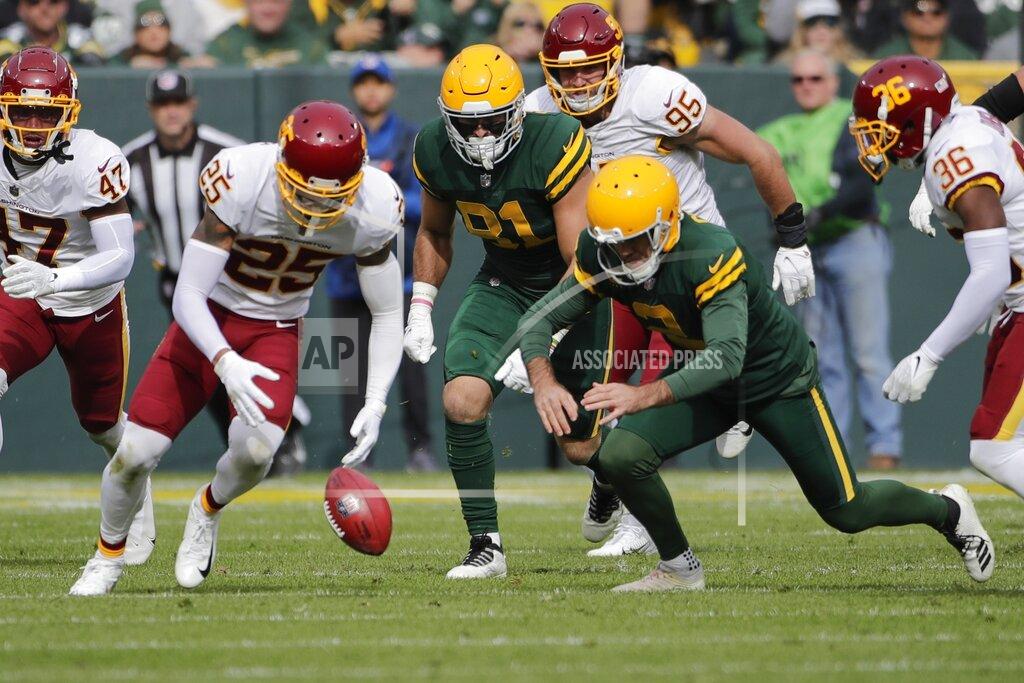 Aaron Gash Green Bay Packers' Mason Crosby and Washington Football Team's Benjamin St-Juste go after a ball after a blocked field goal during the first half of an NFL football game Sunday, Oct. 24, 2021, in Green Bay, Wis. (AP Photo/Aaron Gash)