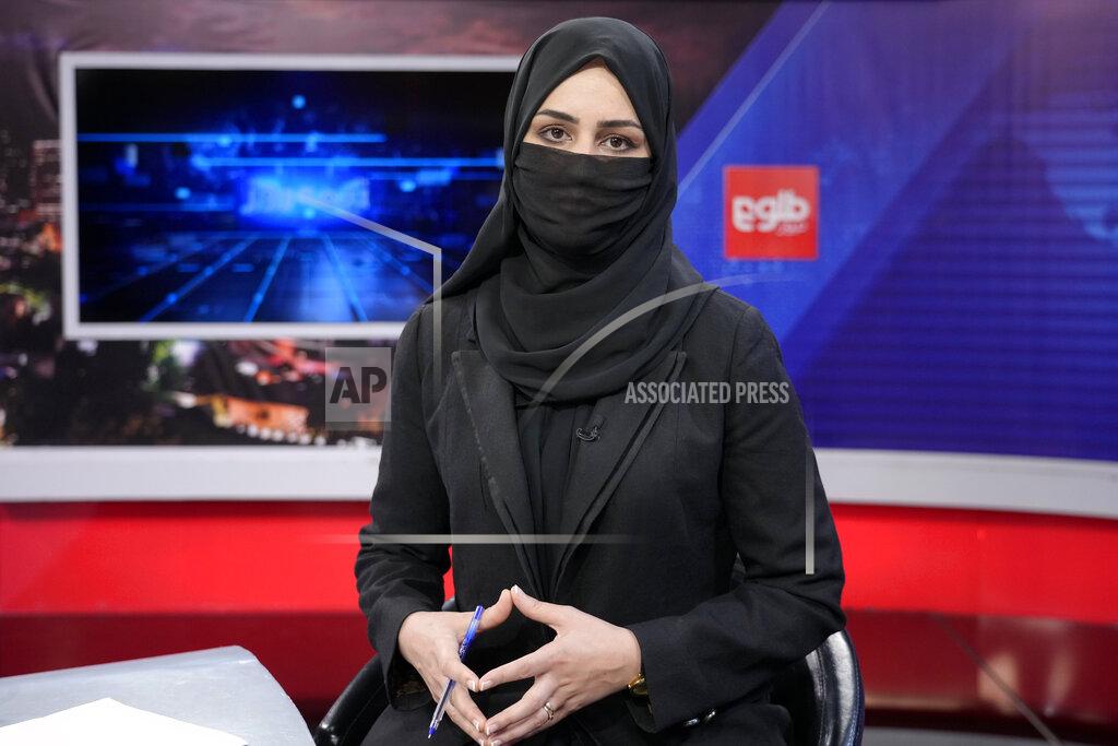 Ebrahim Noroozi TV anchor Khatereh Ahmadi wears a face covering as she reads the news on TOLO NEWS, in Kabul, Afghanistan, Sunday, May 22, 2022. Afghanistan's Taliban rulers have begun enforcing an order requiring all female TV news anchors in the country to cover their faces while on-air. The move Sunday is part of a hard-line shift drawing condemnation from rights activists. (AP Photo/Ebrahim Noroozi)