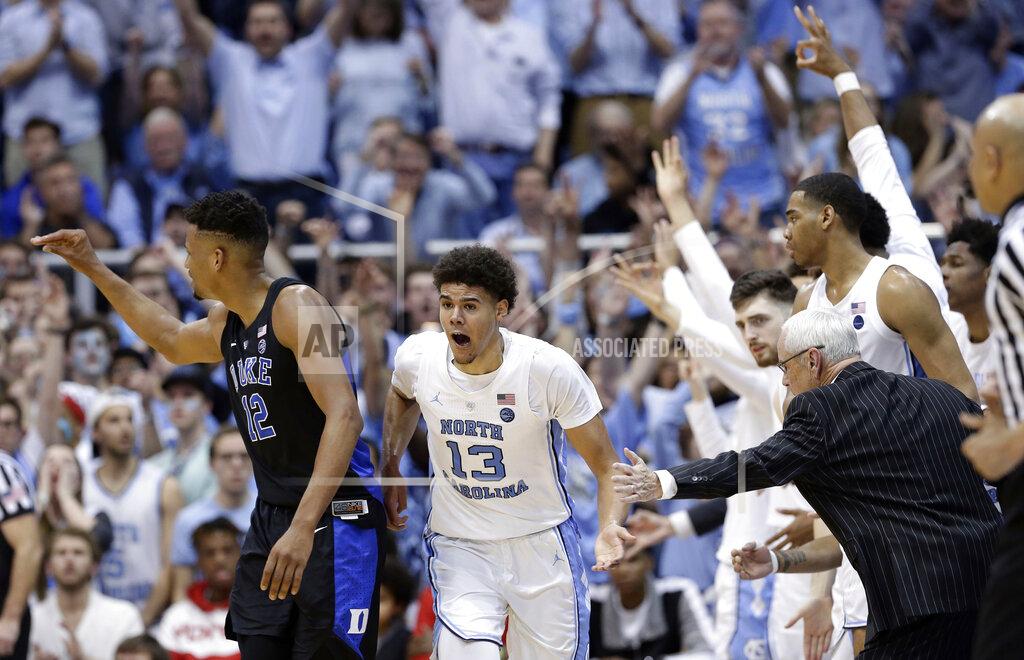 Gerry Broome North Carolina coach Roy Williams reaches for Cameron Johnson (13) following Johnson's basket against Duke while Duke's Javin DeLaurier (12) looks back during the second half of an NCAA college basketball game in Chapel Hill, N.C., Saturday, March 9, 2019. North Carolina won 79-70. (AP Photo/Gerry Broome)