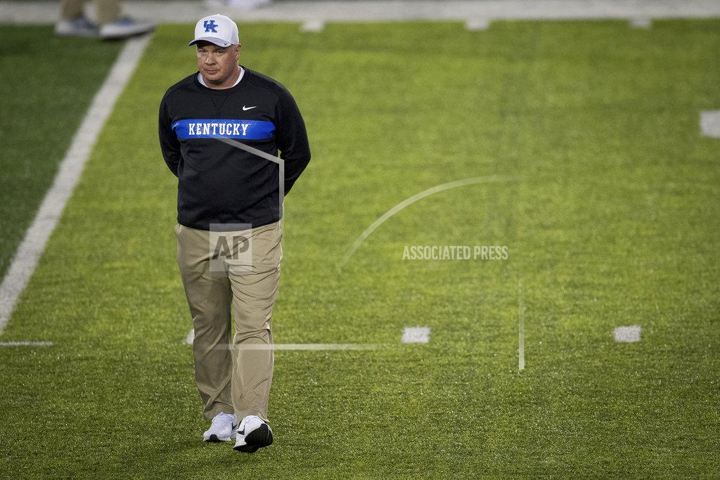 Bryan Woolston FILE - In this Saturday, Oct. 20, 2018, file photo, Kentucky head coach Mark Stoops observes warmups before an NCAA college football game against Vanderbilt in Lexington, Ky. Starting with the World's Largest Outdoor Cocktail Party this weekend, the SEC division title contenders will be meeting over the next two weeks to sort things out. Kentucky may have the easiest road, even with the home game against Georgia. The Wildcats face Missouri, Tennessee, Middle Tennessee and Louisville, teams with a combined 13-15 record. (AP Photo/Bryan Woolston, File)