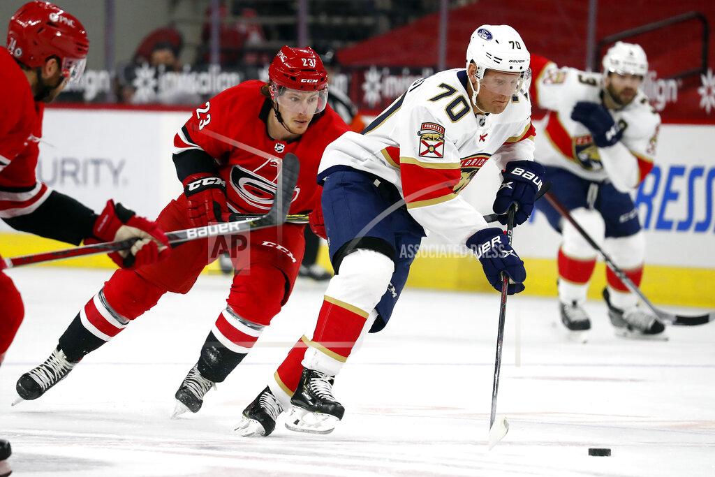 Karl B Deblaker Florida Panthers' Patric Hornqvist (70) skates with the puck after taking it away from Carolina Hurricanes' Brock McGinn (23) during the first period of an NHL hockey game in Raleigh, N.C., Sunday, March 7, 2021. (AP Photo/Karl B DeBlaker)