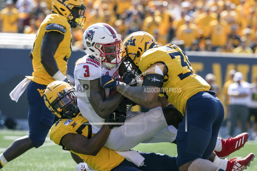 Ray Thompson North Carolina State wide receiver Emeka Emezie (3) is tackled by West Virginia cornerback Hakeem Bailey (24) and linebacker Josh Chandler (35) during the second half of an NCAA college football game Saturday, Sept. 14, 2019, in Morgantown, W.Va. (AP Photo/Raymond Thompson)
