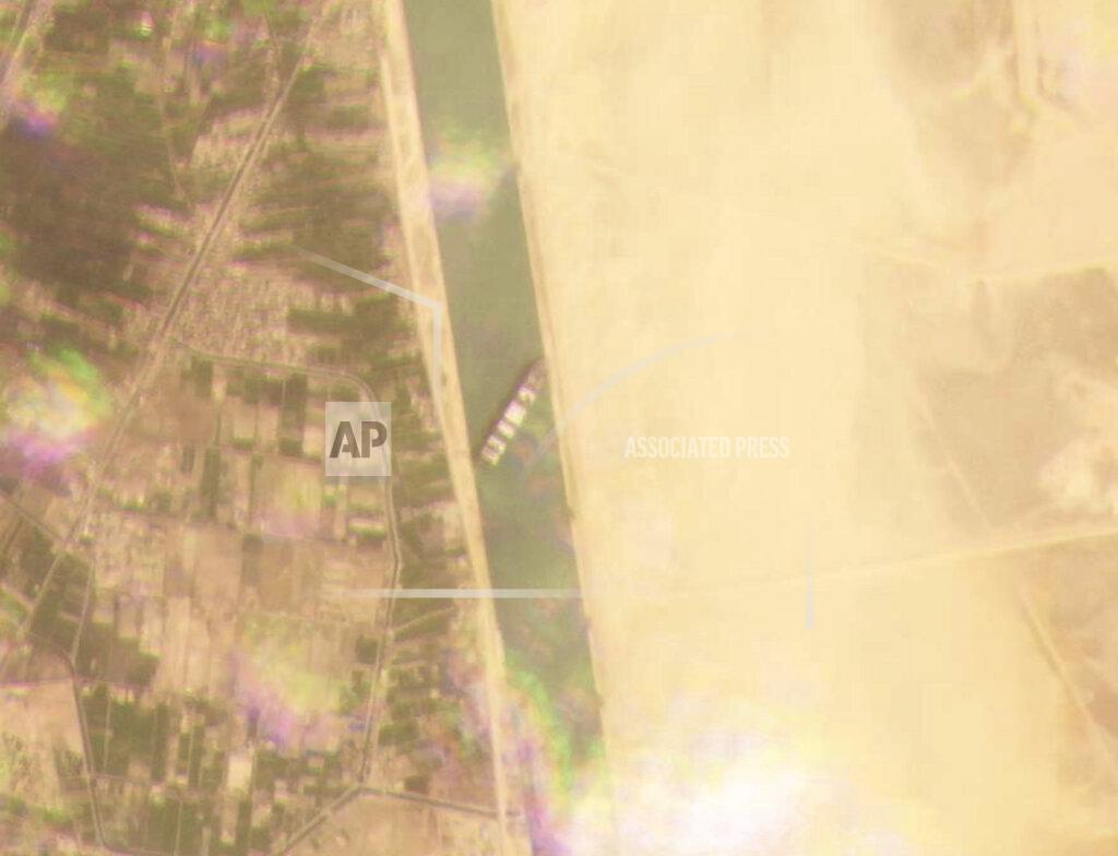 Planet Labs Inc. This satellite image from Planet Labs Inc. shows the cargo ship MV Ever Given stuck in the Suez Canal near Suez, Egypt, Tuesday, March 23, 2021. A cargo container ship that's among the largest in the world has turned sideways and blocked all traffic in Egypt's Suez Canal, officials said Wednesday, March 24, 2021, threatening to disrupt a global shipping system already strained by the coronavirus pandemic. (Planet Labs Inc. via AP)