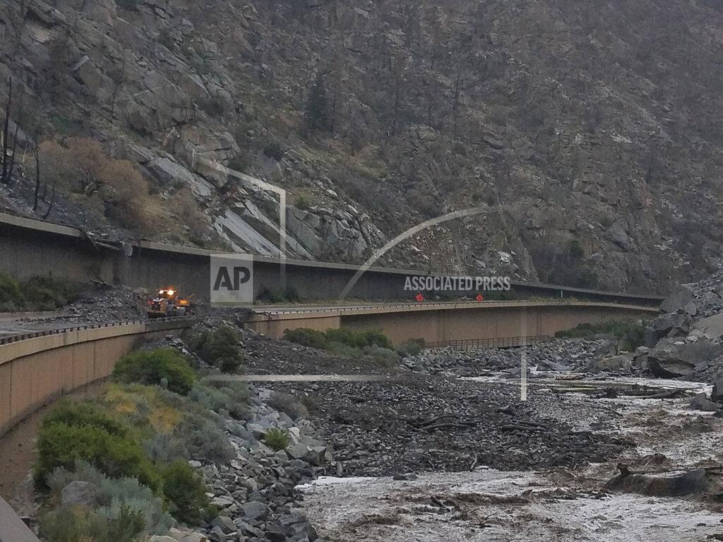 Uncredited In this photo provided by the Colorado Department of Transportation, equipment works to clear mud and debris from a mudslide on Interstate-70 through Glenwood Canyon, Colo., on Friday, July 30, 2021. Authorities say more than 100 people had to spend the night on the highway, including nearly 30 who took refuge inside a highway tunnel along I-70 in Glenwood Canyon after rain over an area burned by a wildfire triggered the mudslides in Western Colorado. The people were caught with their vehicles Thursday night, July 29, 2021 and it took crews nine hours to carve out a path through the mud to reach them about 6:30 a.m. Friday, Garfield County Sheriff's Office spokesman Walt Stowe said. (Colorado Department of Transportation via AP)