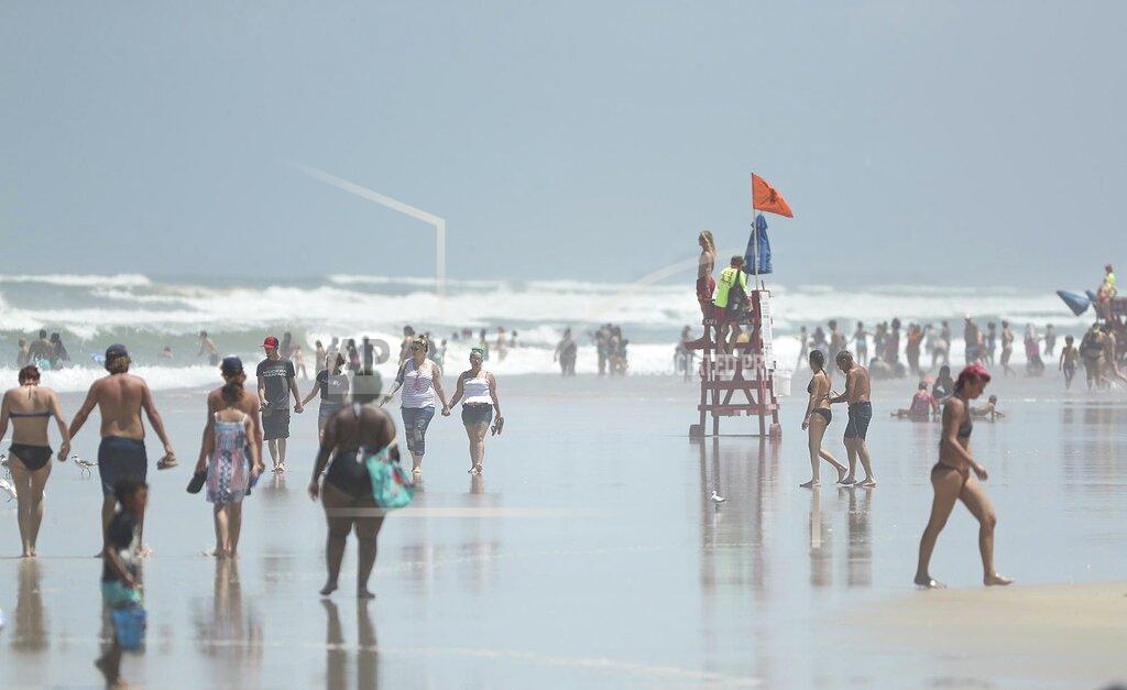 Stephen M. Dowell Daytona Beach, Fla., is crowded with beachgoers Saturday, Aug. 1, 2020. Isaias is expected to regain hurricane strength before reaching Florida. Though officials do not expect to have to evacuate people, they wrestled with how to prepare shelters where people can seek refuge from the storm if necessary, while safely social distancing to prevent the spread of the coronavirus. (Stephen M. Dowell/Orlando Sentinel via AP)