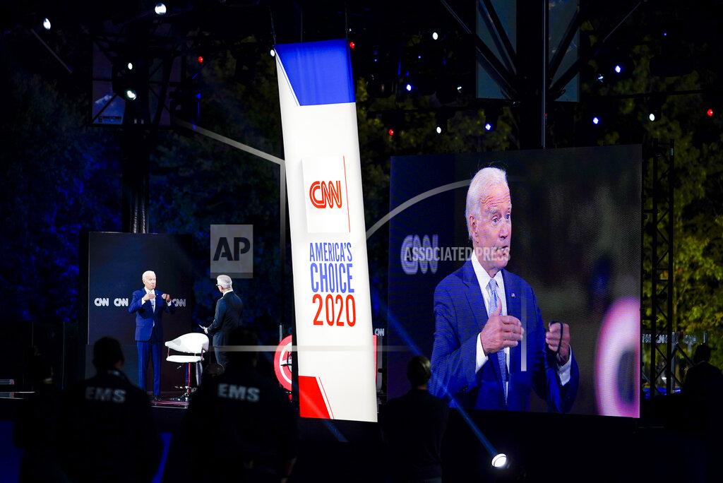 Carolyn Kaster Democratic presidential candidate former Vice President Joe Biden, left, participates in a CNN drive-in town hall moderated by Anderson Cooper in Moosic, Pa., Thursday, Sept. 17, 2020. At right Biden's image is projected onto a video monitor. (AP Photo/Carolyn Kaster)