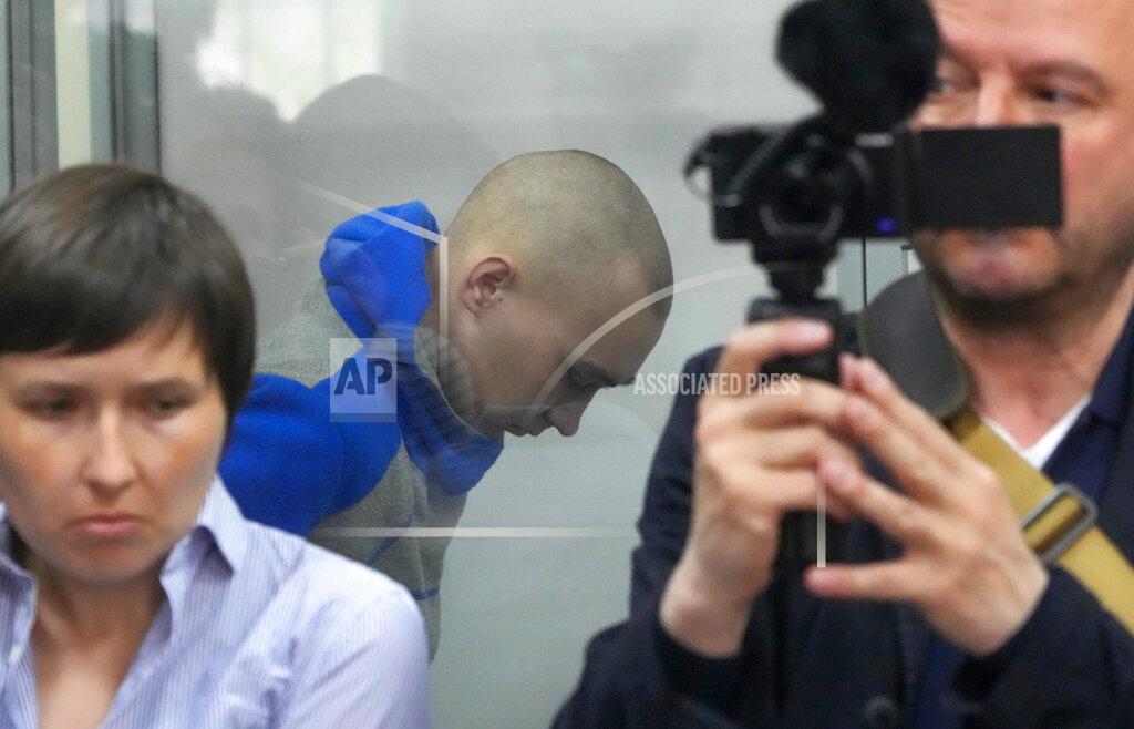 Efrem Lukatsky Russian army Sergeant Vadim Shishimarin, 21, is seen behind a glass during a court hearing in Kyiv, Ukraine, Friday, May 13, 2022. The trial of a Russian soldier accused of killing a Ukrainian civilian opened Friday, the first war crimes trial since Moscow's invasion of its neighbor. (AP Photo/Efrem Lukatsky)