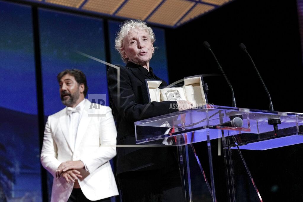 Joel C Ryan Javier Bardem, left, looks on as Claire Denis accepts the grand prize for 'Stars at Noon' during the awards ceremony of the 75th international film festival, Cannes, southern France, Saturday, May 28, 2022. (Photo by Joel C Ryan/Invision/AP)