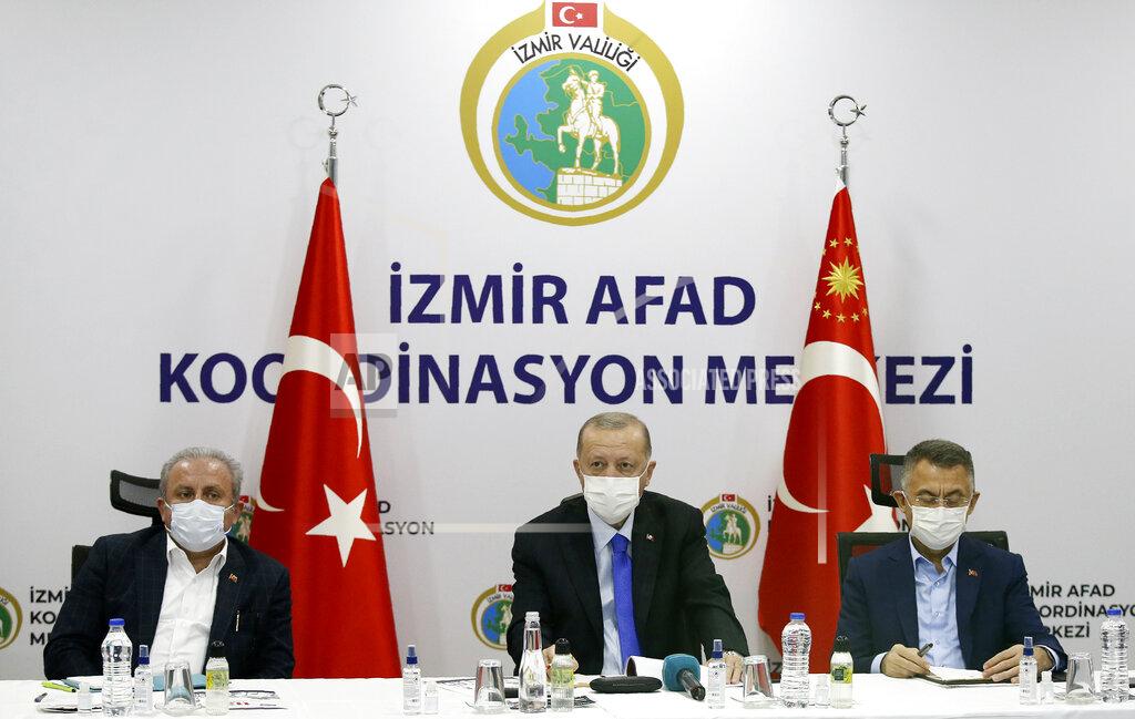 Uncredited Turkey's President Recep Tayyip Erdogan, centre, flanked by his deputy Fuat Oktay, right, and Parliament Speaker Mustafa Sentop, speaks at Izmir AFAD emergency response center, in Izmir, Turkey, Saturday, Oct. 31, 2020. Three young children and their mother were rescued alive from the rubble of a collapsed building in western Turkey on Saturday, some 23 hours after a powerful earthquake in the Aegean Sea killed several people and injured more than 800 others.(Turkish Presidency via AP, Pool)