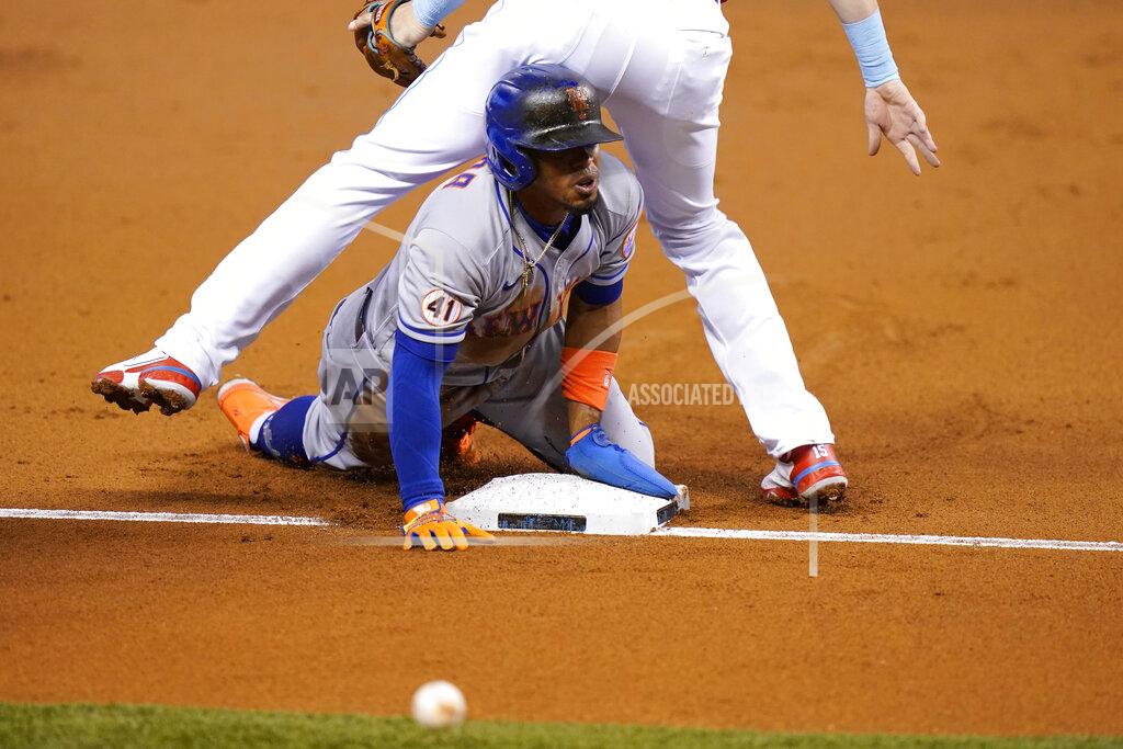 Lynne Sladky New York Mets' Francisco Lindor slides safely into third before going on to score on a throwing error by Miami Marlins center fielder Magneuris Sierra during the first inning of a baseball game Friday, May 21, 2021, in Miami. (AP Photo/Lynne Sladky)