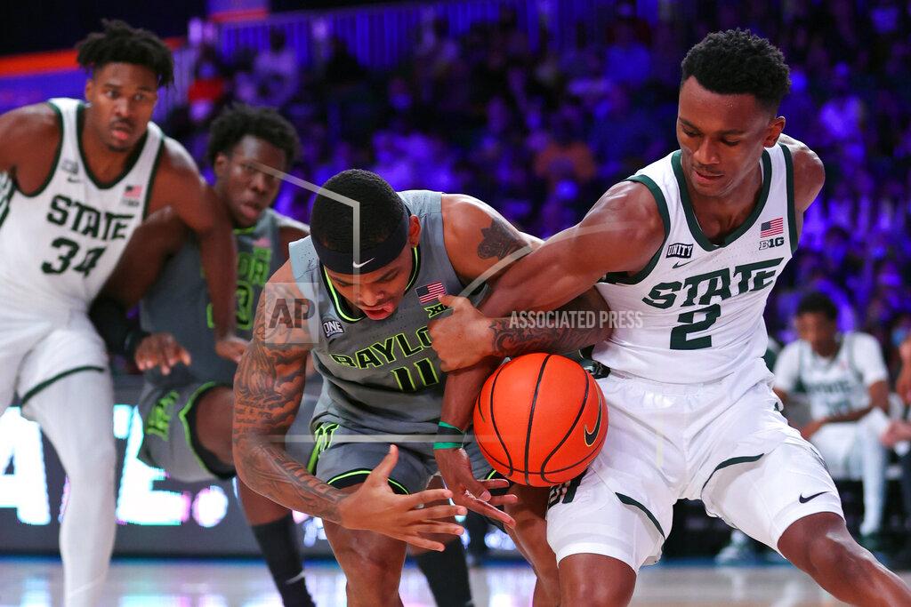 Tim Aylen In this photo provided by Bahamas Visual Services, Baylor guard James Akinjo (11) and Michigan State guard Tyson Walker (2) battle for the ball during an NCAA college basketball game at Paradise Island, Bahamas, Friday, Nov. 26, 2021. (Tim Aylen/Bahamas Visual Services via AP)
