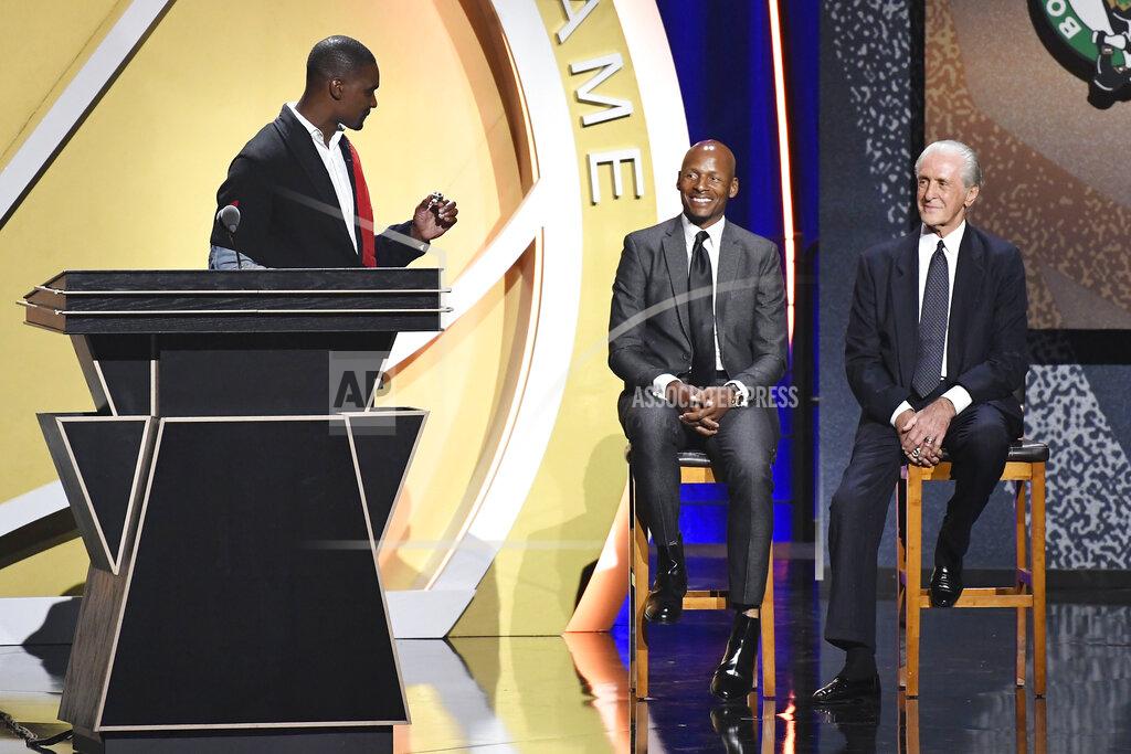 Jessica Hill Inductee Chris Bosh holds up a ring to give to Pat Riley, right, as Ray Allen looks on during the 2021 Basketball Hall of Fame Enshrinement ceremony, Saturday, Sept. 11, 2021, in Springfield, Mass. (AP Photo/Jessica Hill)