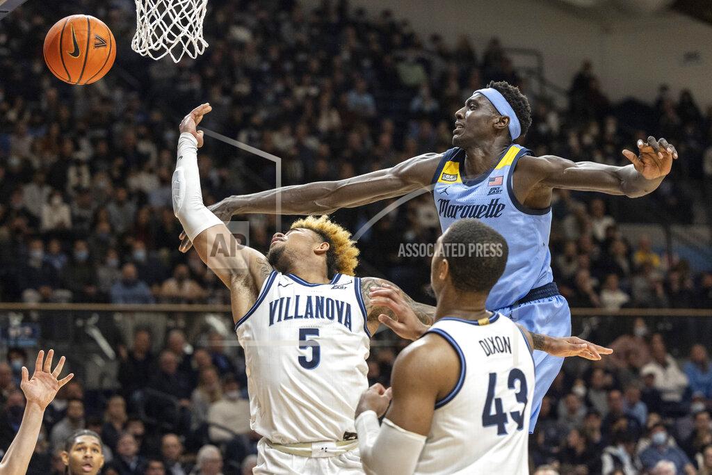 Laurence Kesterson Marquette forward Kur Kuath (35) deflects a shot by Villanova guard Justin Moore (5) as forward Eric Dixon (43) follows during the second half of an NCAA college basketball game, Wednesday, Jan. 19, 2022, in Villanova, Pa. (AP Photo/Laurence Kesterson)