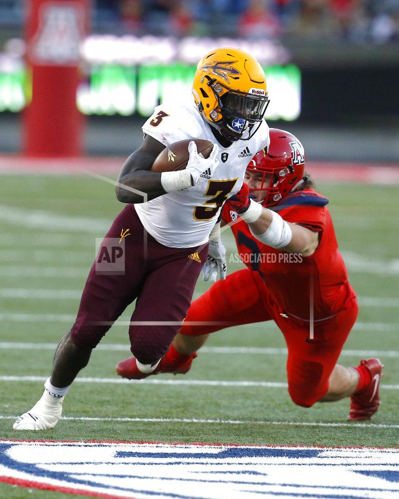 Rick Scuteri Arizona State running back Eno Benjamin (3) breaks the tackle of Arizona linebacker Colin Schooler in the second half during an NCAA college football game, Saturday, Nov. 24, 2018, in Tucson, Ariz. (AP Photo/Rick Scuteri)