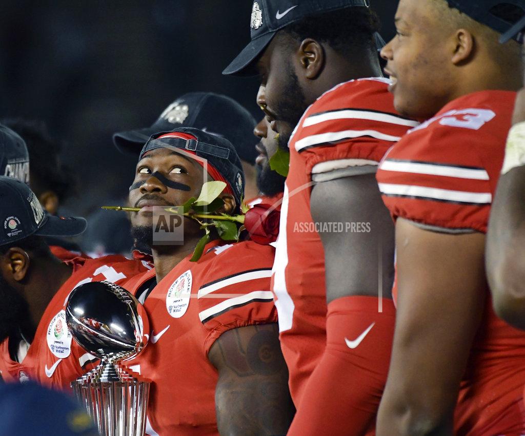 Mark J. Terrill Ohio State wide receiver Johnnie Dixon holds the trophy after Ohio State's 28-23 win over Washington in the Rose Bowl NCAA college football game Tuesday, Jan. 1, 2019, in Pasadena, Calif. (AP Photo/Mark J. Terrill)