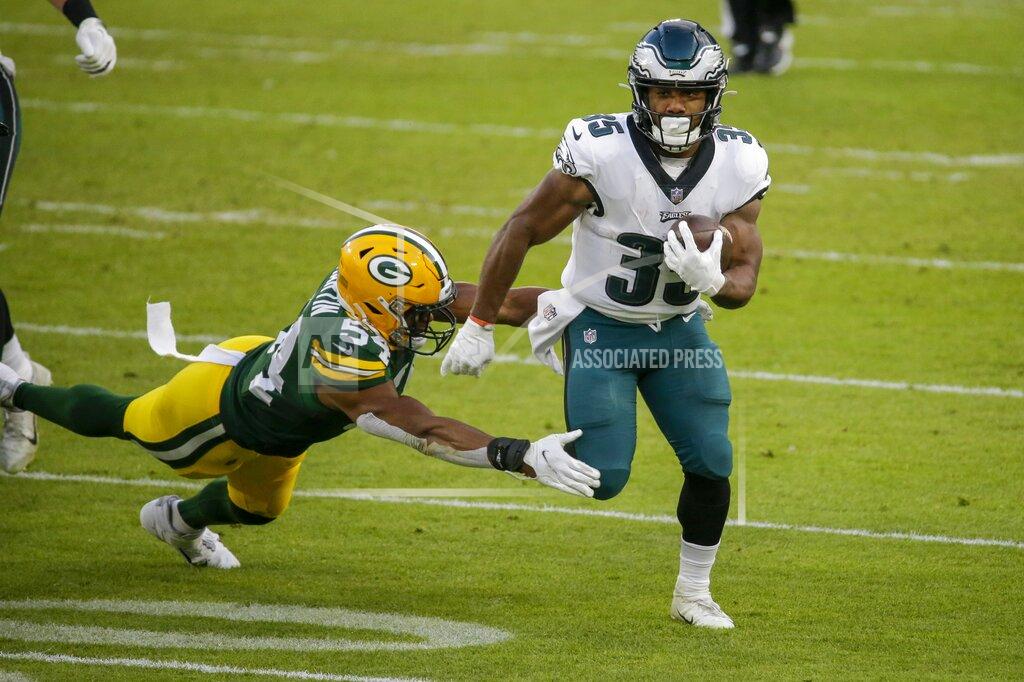 Mike Roemer Philadelphia Eagles' Boston Scott runs past Green Bay Packers' Kamal Martin during the first half of an NFL football game Sunday, Dec. 6, 2020, in Green Bay, Wis. (AP Photo/Mike Roemer)