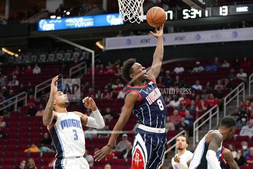 Houston Rockets forward Jae'Sean Tate (8) drives past Orlando Magic forward Chuma Okeke (3) during the first half of an NBA basketball game Friday, Dec. 3, 2021, in Houston. (AP Photo/Eric Christian Smith)