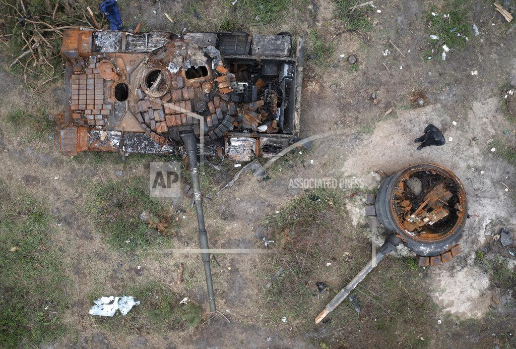 Efrem Lukatsky A man passes by Russian tanks destroyed in a recent battle against Ukrainians in the village of Dmytrivka, close to Kyiv, Ukraine, Monday, May 23, 2022. (AP Photo/Efrem Lukatsky)