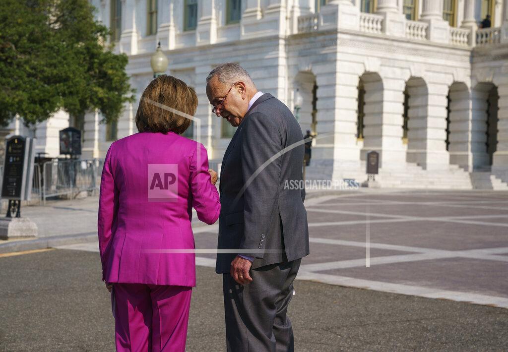 J. Scott Applewhite Speaker of the House Nancy Pelosi, D-Calif., left, and Senate Majority Leader Chuck Schumer, D-N.Y., speak privately before an event to address the need to counter climate change in the US with transformational investments in clean jobs, at the Capitol in Washington, Wednesday, July 28, 2021. (AP Photo/J. Scott Applewhite)