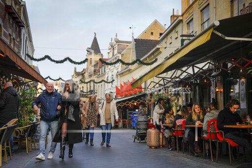 People enjoy the reopening of bars in Valkenburg, southern Netherlands, Friday, Jan. 14, 2022, where shops, bars and restaurants opened in a protest action that underscored growing anger at weeks of coronavirus lockdown measures, a day before some of the restrictions are expected to be eased. (AP Photo/Peter Dejong)