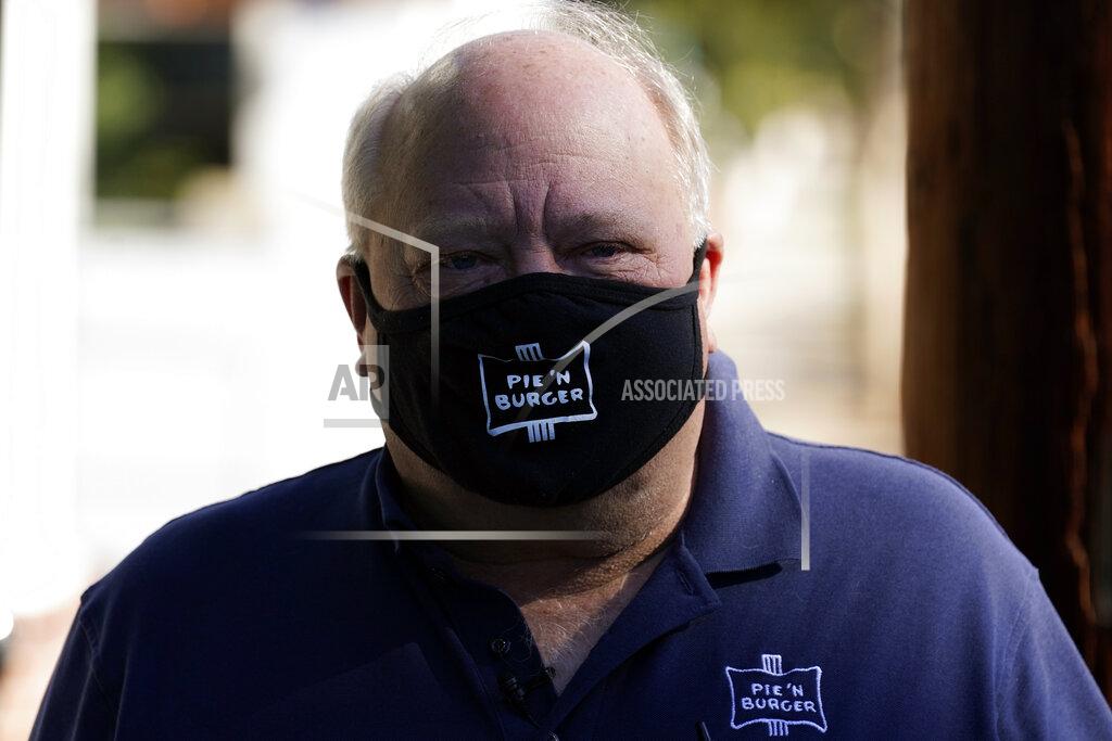 Marcio Jose Sanchez *** Hold For Story *** Pie 'N Burger owner Michael Osborn stands outside his restaurant Tuesday, Dec. 1, 2020, in Pasadena, Calif. Pasadena has become an island in the center of the nation's most populous county, where a surge of COVID-19 cases last week led to a three-week end to outdoor dining and California's first stay-home order since the pandemic began to spread across the state in March. (AP Photo/Marcio Jose Sanchez)