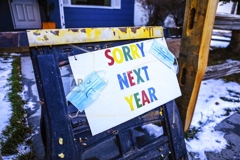 Chris Dillmann A sign indicates that residents of a house will not be handing out treats for Halloween during the coronavirus pandemic, Friday, Oct. 30, 2020, in Minturn, Colo. (AP Photo/Vail Daily via AP)
