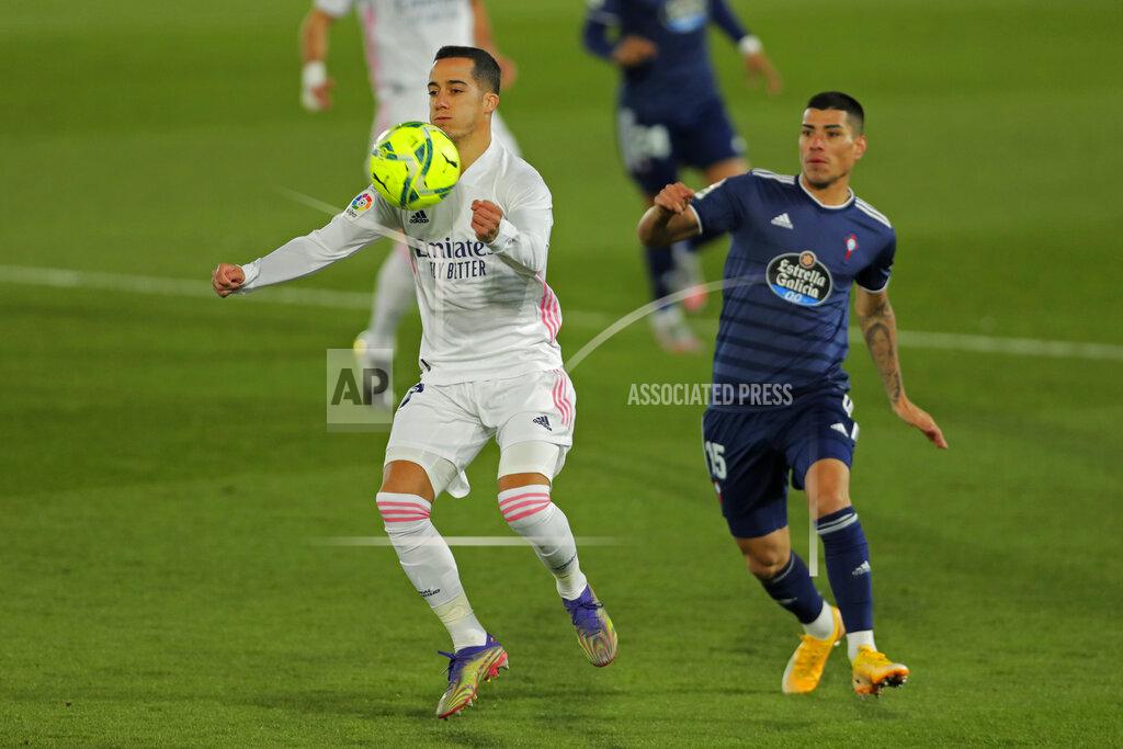 Manu Fernandez Real Madrid's Lucas Vazquez, left, vies for the ball with Celta Vigo's Lucas Olaza during the Spanish La Liga soccer match between Real Madrid and Celta Vigo at the Alfredo Di Stefano stadium in Madrid, Spain, Saturday, Jan. 2, 2021. (AP Photo/Manu Fernandez)