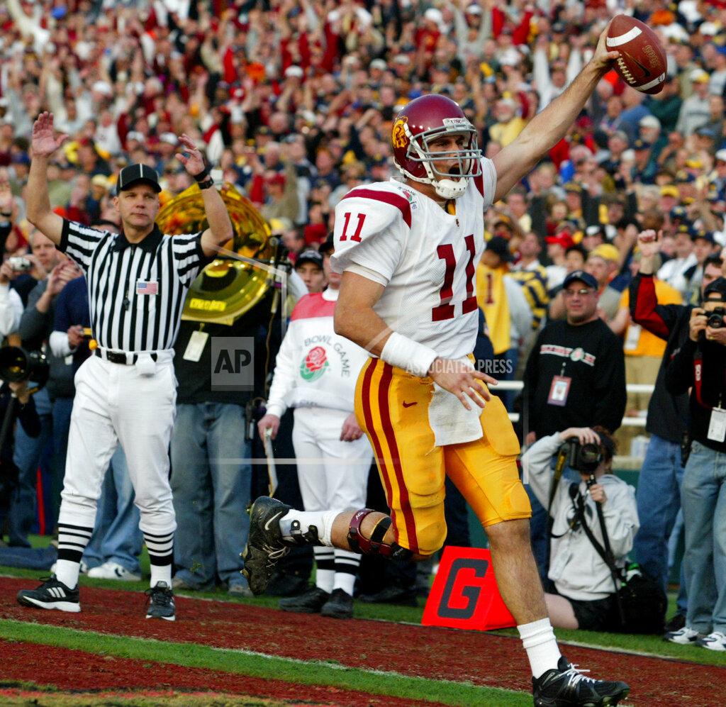 Nam Y. Huh FILE - In this Jan. 1, 2004, file photo, Southern California quarterback Matt Leinart scores during the third quarter on a 15-yard pass completion thrown by USC wide receiver Mike Williams against Michigan in the 90th Rose Bowl in Pasadena, Calif. At the start of the play, Leinart tossed a lateral pass to White. USC set a record by going 33 straight polls as No. 1 from 2003-05. The Trojans weren’t just the best team in college football, they were also arguably the coolest, with the charismatic, laid-back Carroll leading stars like quarterback Matt Leinart and running back Reggie Bush to victory after victory. (AP Photo/Nam Y. Huh, File)