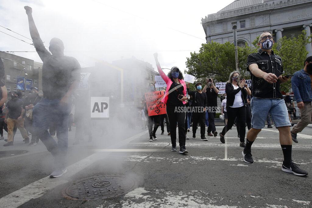 Jeff Chiu People march toward City Hall during a protest over the Memorial Day death of George Floyd, a handcuffed black man in police custody in Minneapolis, in San Francisco, Saturday, May 30, 2020. (AP Photo/Jeff Chiu)