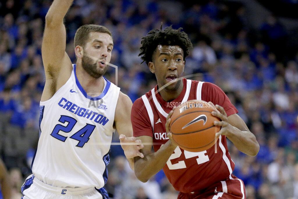Nati Harnik Oklahoma's Jamal Bieniemy, right, drives to the basket against Creighton's Mitch Ballock (24) during the first half of an NCAA college basketball game in Omaha, Neb., Tuesday, Dec. 17, 2019. (AP Photo/Nati Harnik)