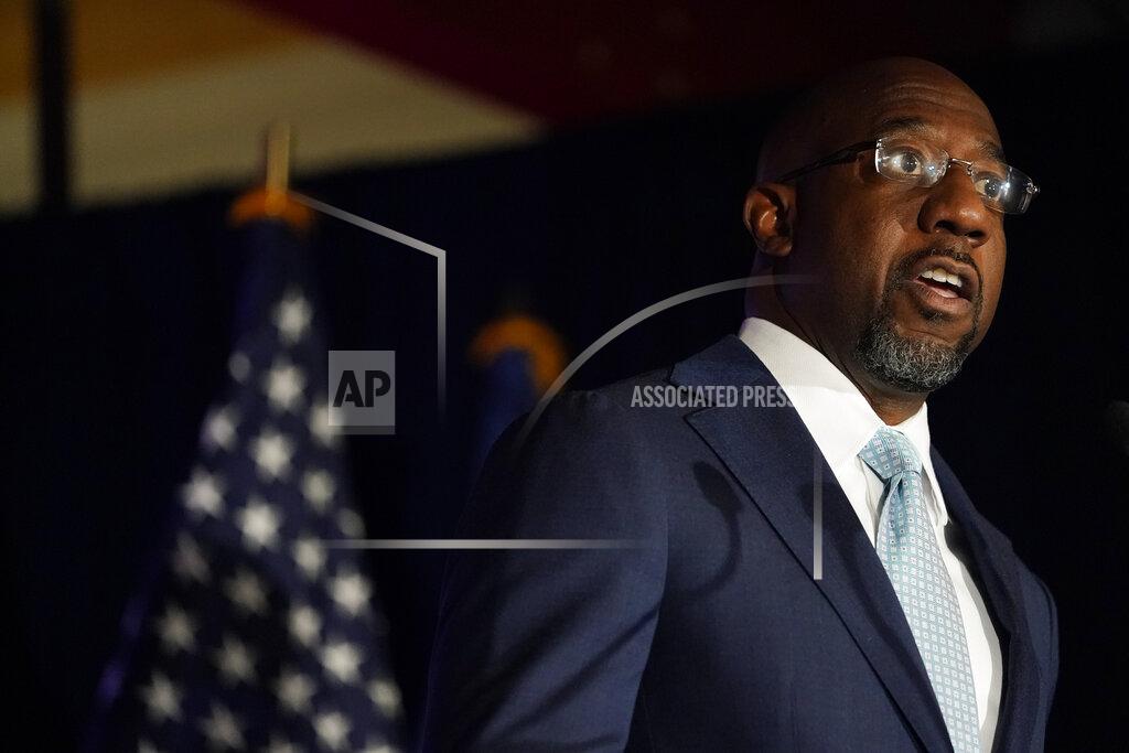 Brynn Anderson Raphael Warnock, a Democratic candidate for the U.S. Senate speaks during a rally, Tuesday, Nov. 3, 2020, in Atlanta. (AP Photo/Brynn Anderson, Pool)