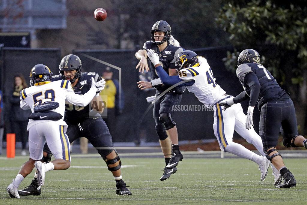 Mark Humphrey Vanderbilt quarterback Riley Neal throws as he is hit by ETSU defensive lineman Nasir Player (45) in the first half of an NCAA college football game Saturday, Nov. 23, 2019, in Nashville, Tenn. (AP Photo/Mark Humphrey)