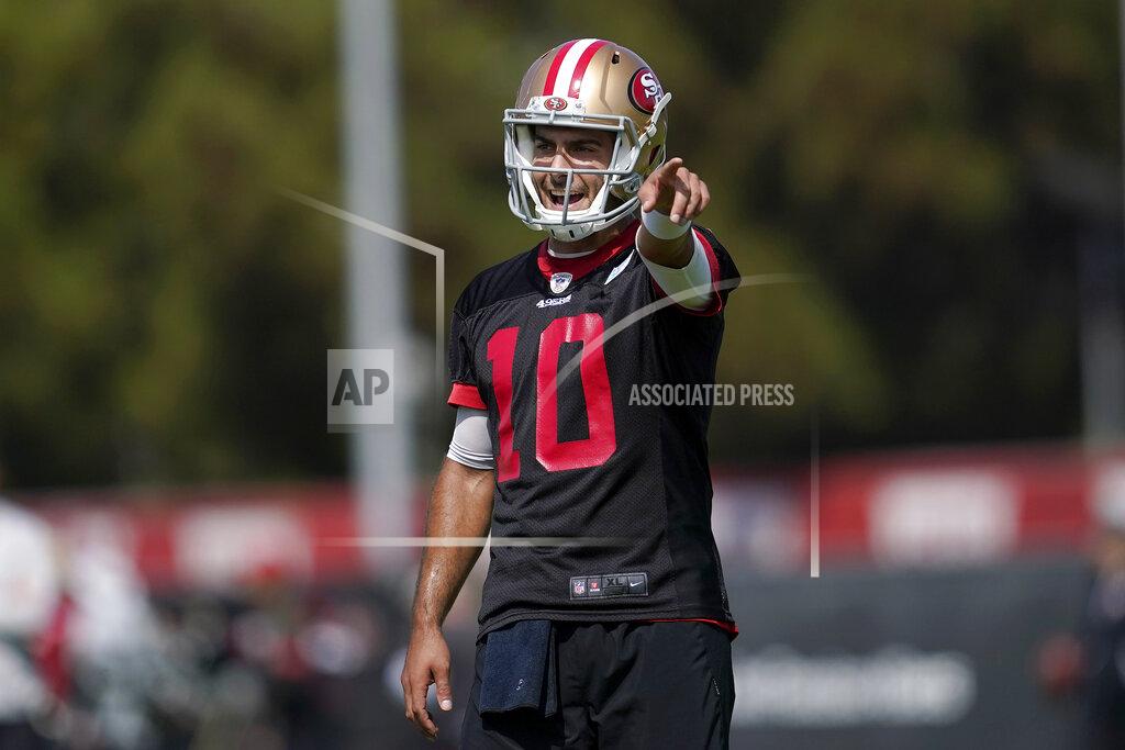 Jeff Chiu San Francisco 49ers quarterback Jimmy Garoppolo gestures toward teammates at NFL football training camp in Santa Clara, Calif., Wednesday, July 28, 2021. (AP Photo/Jeff Chiu)