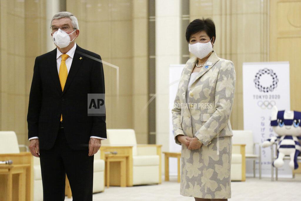 Koji Sasahara International Olympic Committee President Thomas Bach, left, and Tokyo Governor Yuriko Koike, right, pose for a photo, before their meeting in Tokyo, Monday, Nov. 16, 2020. IOC President Bach is beginning a visit to Tokyo to convince politicians and the Japanese public that the postponed Olympics will open in just over eight months.(AP Photo/Koji Sasahara)