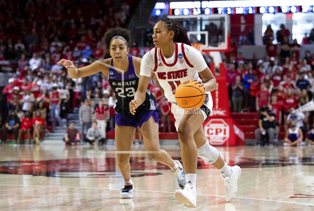 Ben Mckeown North Carolina State's Jakia Brown-Turner (11) drives past Kansas State's Jada Moore (23) during the second half of a college basketball game in the second round of the NCAA tournament in Raleigh, N.C., Monday, March 21, 2022. (AP Photo/Ben McKeown)