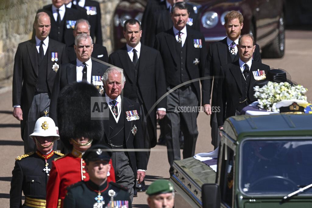 Leon Neal From front left, Britain's Prince Charles, Prince Andrew. Prince Edward, Prince William, Peter Phillips, Prince Harry, Earl of Snowdon and Tim Laurence follow the coffin the coffin makes it's way past the Round Tower during the funeral of Britain's Prince Philip inside Windsor Castle in Windsor, England Saturday April 17, 2021. (Leon Neal/Pool via AP)