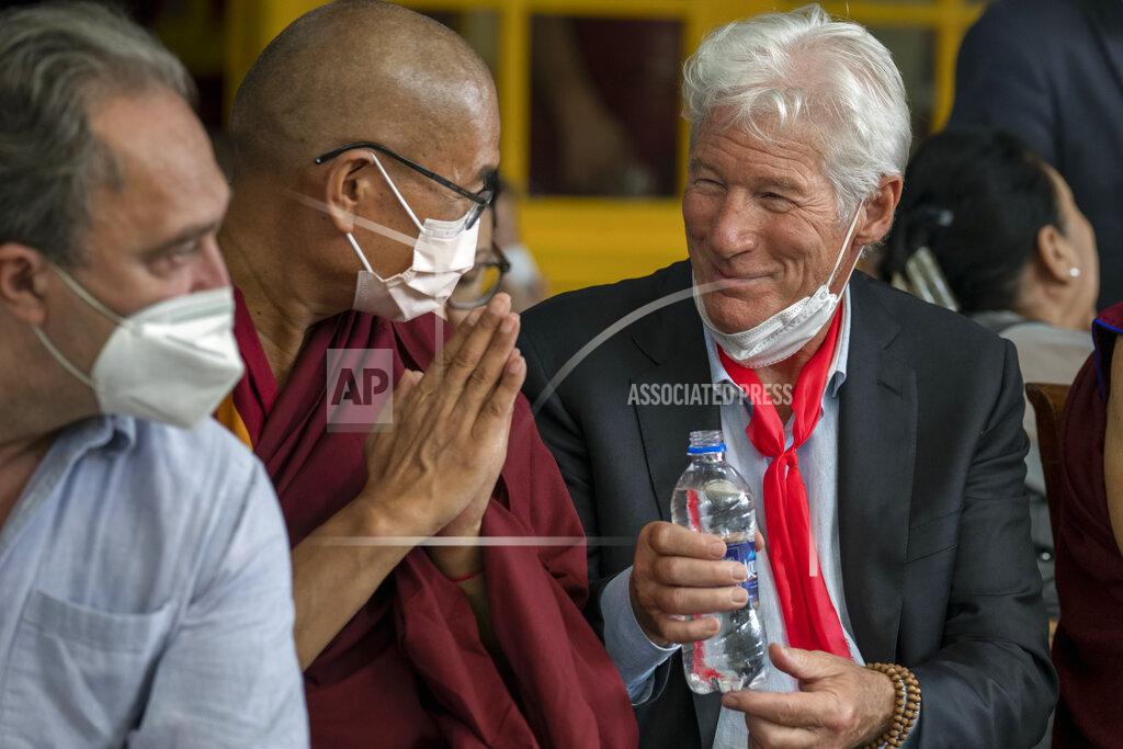 Ashwini Bhatia Hollywood actor Richard Gere offers water to a Buddhist monk sitting next to him as he attends an event to mark the 87th birthday of Tibetan spiritual leader the Dalai Lama in Dharmsala, India, Wednesday, July 6, 2022. (AP Photo/Ashwini Bhatia)