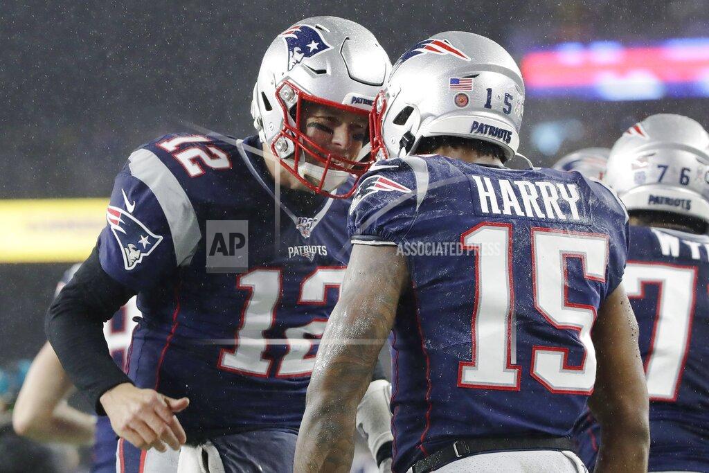 Elise Amendola New England Patriots quarterback Tom Brady, left, celebrates his touchdown pass to wide receiver N'Keal Harry, right, in the first half of an NFL football game against the Dallas Cowboys, Sunday, Nov. 24, 2019, in Foxborough, Mass. (AP Photo/Elise Amendola)
