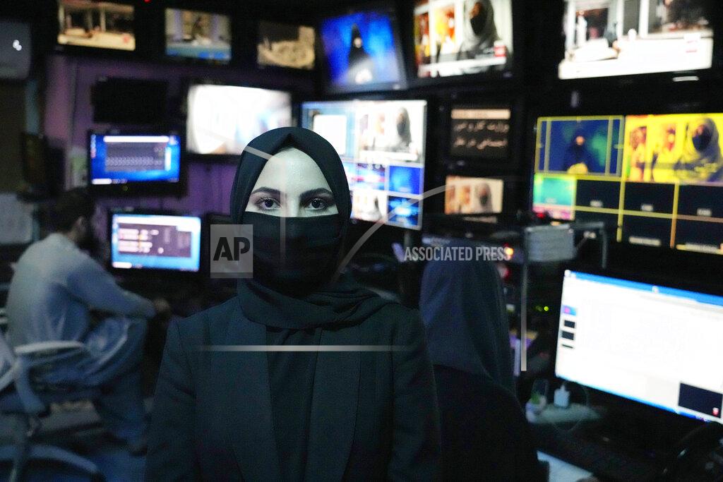 Ebrahim Noroozi Sonia Niazi a TV anchor works in a TOLO NEWS studio while covering her face, in Kabul, Afghanistan, Sunday, May 22, 2022. Afghanistan's Taliban rulers have begun enforcing an order requiring all female TV news anchors in the country to cover their faces while on-air. The move Sunday is part of a hard-line shift drawing condemnation from rights activists. (AP Photo/Ebrahim Noroozi)